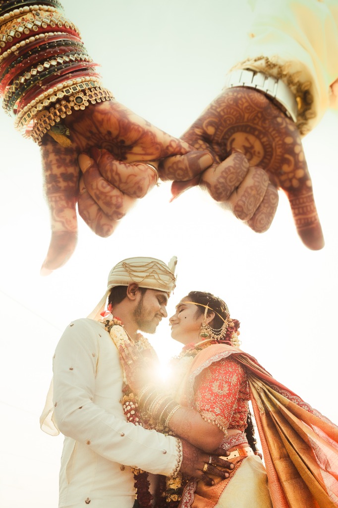 Wedding couple holding hands close-up detail